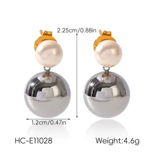 Detail of stainless steel earrings with pearl beads and silver spherical drops