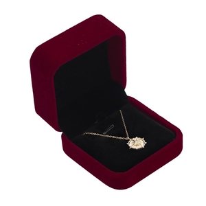 Golden sunburst star pendant necklace presented in a luxury red velvet jewelry gift box