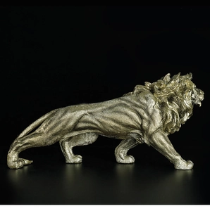 Close-up of golden lion resin statue showing detailed muscle texture and antique finish