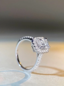 Macro side view of S925 sterling silver emerald cut ring with a halo of sparkling diamonds