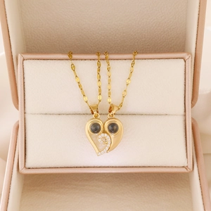 Macro detail of magnetic heart-shaped pendant necklaces for couples in a gift box