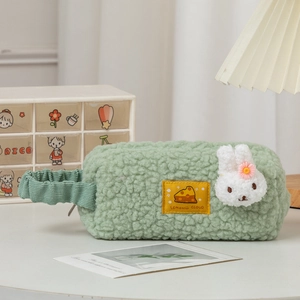 Detail of green plush bunny stationery pouch with soft lamb wool and corduroy handle
