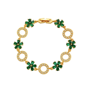 Exquisite gold floral bracelet with emerald green stones and white cubic zirconia on white back