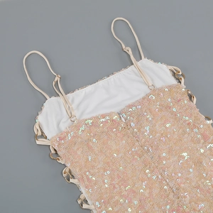 Close-up of champagne pink sequin dress showing strap detail and metal rings