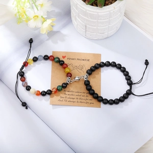 Close-up of magnetic heart clasp on tiger eye bead bracelets for couples gift
