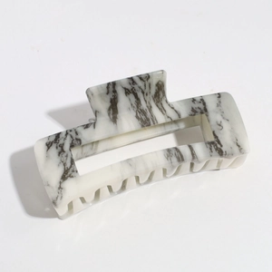 Detail of square hair claw clip featuring elegant black and white marble ink texture
