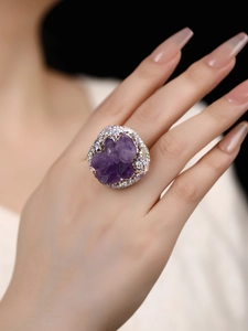 Detailed view of irregular raw purple amethyst crystal ring with sparkling rhinestones
