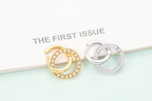 Close-up of gold and silver circular earrings with micro-pave cubic zirconia stones