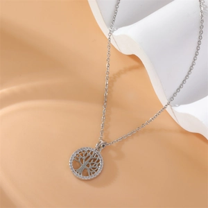 Macro shot of silver tree of life pendant with sparkling zircons on a geometric chain