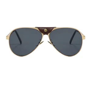 Retro pilot sunglasses with gold metal frame, dark lenses and brown leather bridge detail