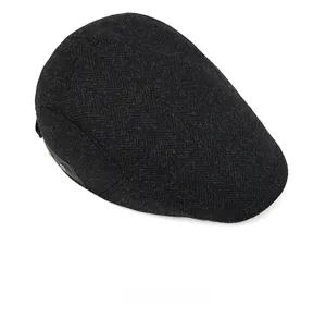 Detailed top view of wool herringbone flat cap fabric texture and classic weave pattern