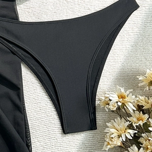 Detailed close-up of premium black swimwear bottoms with precise double-needle stitching