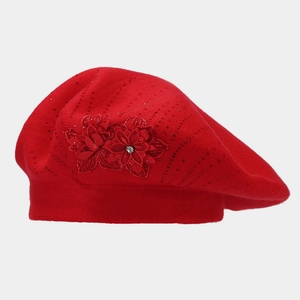 Detail of red knit beret featuring 3D fabric flowers and sparkling rhinestone accents