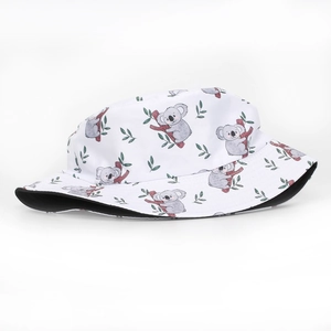 Close-up of white bucket hat featuring cute cartoon sloth and green leaf patterns