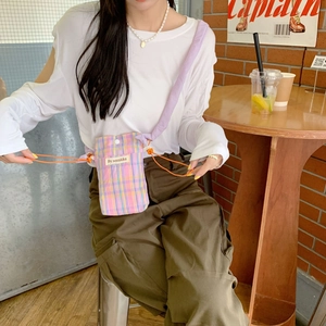 Minimalist pink and blue checkered crossbody bag with orange drawstring and wide lilac strap
