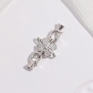 Macro detail of silver S925 clover clasp with sparkling pavé cubic zirconia stones