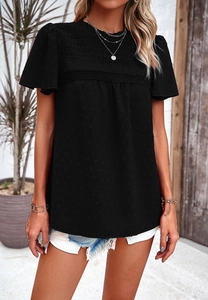 Detail of short sleeve top with bubble sleeves, lace patchwork and polka dot texture