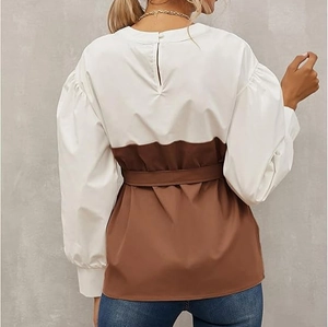 Detail of white and brown patchwork blouse featuring back keyhole button and tie-waist