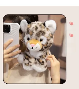 Detail showing plush leopard toy with realistic spots and soft texture held by a person
