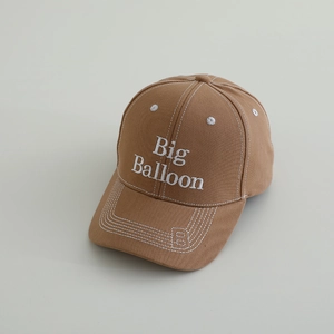 Detailed embroidery of Big Balloon and white stitching on a brown cotton baseball cap