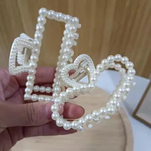 Elegant large pearl hair claw clips featuring rectangular and heart shapes with metal springs