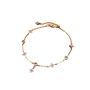 Gold plated bracelet with four-petal flower zircon charms and round sparkling stones