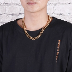 Close-up of a male model wearing a premium gold-plated Cuban link chain necklace