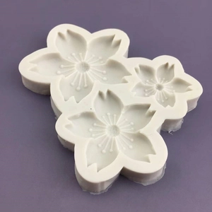 White silicone cherry blossom mold with three flower shapes for cake decorating