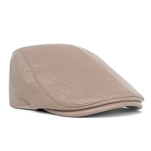 Close-up of light brown faux leather beret featuring detailed stitching and retro texture