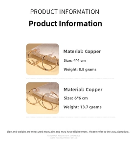 Detailed view of twisted gold hoop earrings in 4cm and 6cm sizes on minimalist stone props