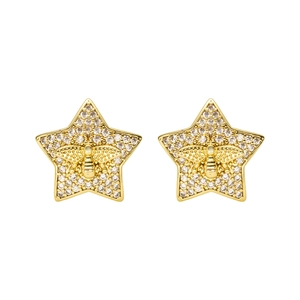 Star-shaped gold stud earrings with sparkling crystals and central honey bee motif