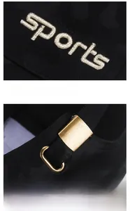 Detail of black baseball cap with sports embroidery and adjustable metal buckle
