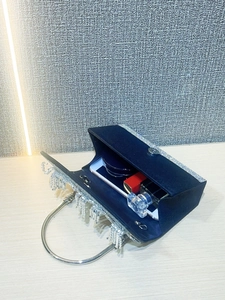 Detail view of navy blue velvet evening clutch bag with rhinestones and internal capacity