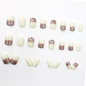 Short square press-on nails with milky white to rose gradient and silver glitter accents