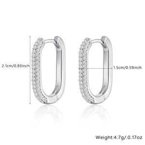 Macro shot of silver oval hoop earrings featuring dense pave-set zircons and size specs