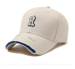 Close-up of distressed brim detail and embroidered R letter on cotton baseball cap