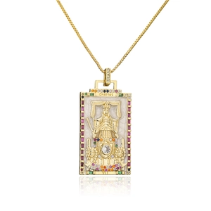 Macro shot of 18K gold tarot chariot pendant with mother of pearl and colorful gems