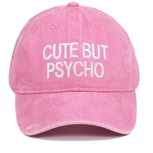 Close-up of pink washed baseball cap with white CUTE BUT PSYCHO 3D embroidery detail