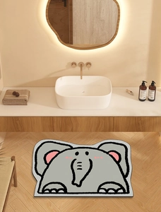 Detail of grey elephant shaped diatom mud bath mat on a modern bathroom wooden floor
