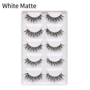 Detail view of 5 pairs of natural manga false eyelashes on a white matte tray