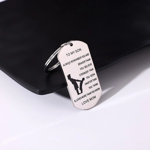 Detailed view of stainless steel military dog tag keychain with laser engraved message