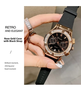 Detail of rose gold quartz watch with black silicone strap and crystal bezel