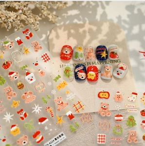 Close-up of Christmas nail stickers with cute cartoon bears and festive winter patterns