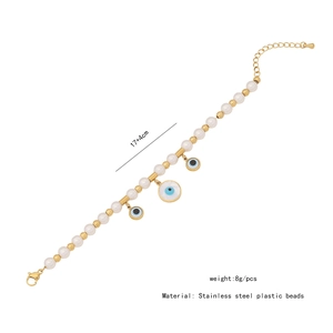 Detail of beaded evil eye bracelet with white pearls and gold stainless steel beads