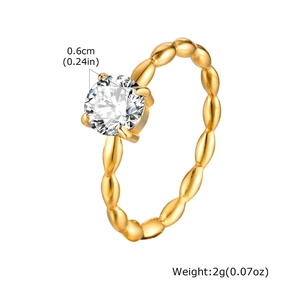 Close-up of golden Mobius ring with 0.6cm round zircon inlay and beaded band detail