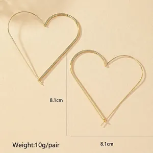Detailed size view of gold heart hoop earrings showing 8.1cm diameter and 10g weight