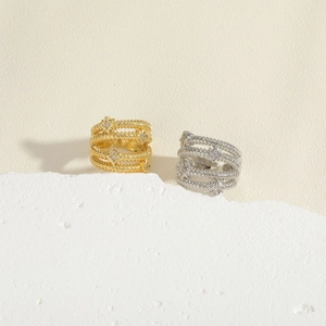 Detail showing gold and silver multi-layer rings with star elements on stone base