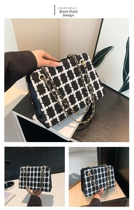 Detail of black and white tweed texture and gold chain strap on an elegant crossbody bag