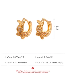 Detailed view of gold butterfly hoop earrings set with lavender crystals and copper base