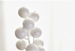 Macro detail of white Christmas berry branch with glitter texture and frosted finish